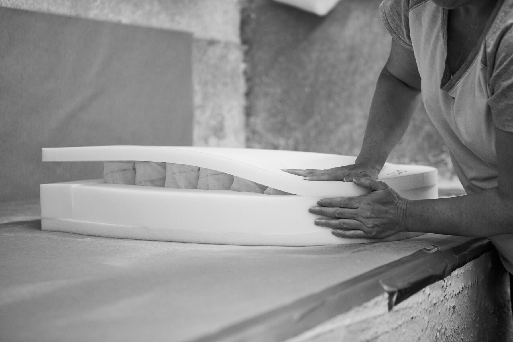 Chaddock craftsman hand-shaping foam cushion construction